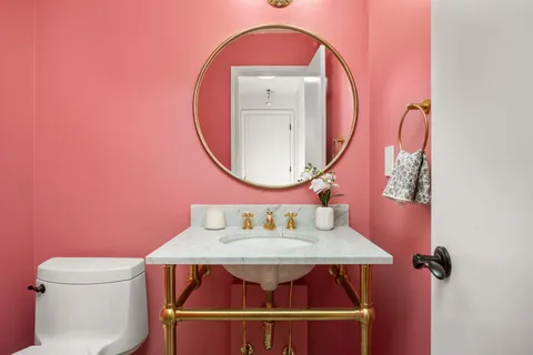 a room with a wooden floor a toilet and a sink