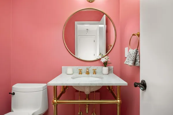 a room with a wooden floor a toilet and a sink