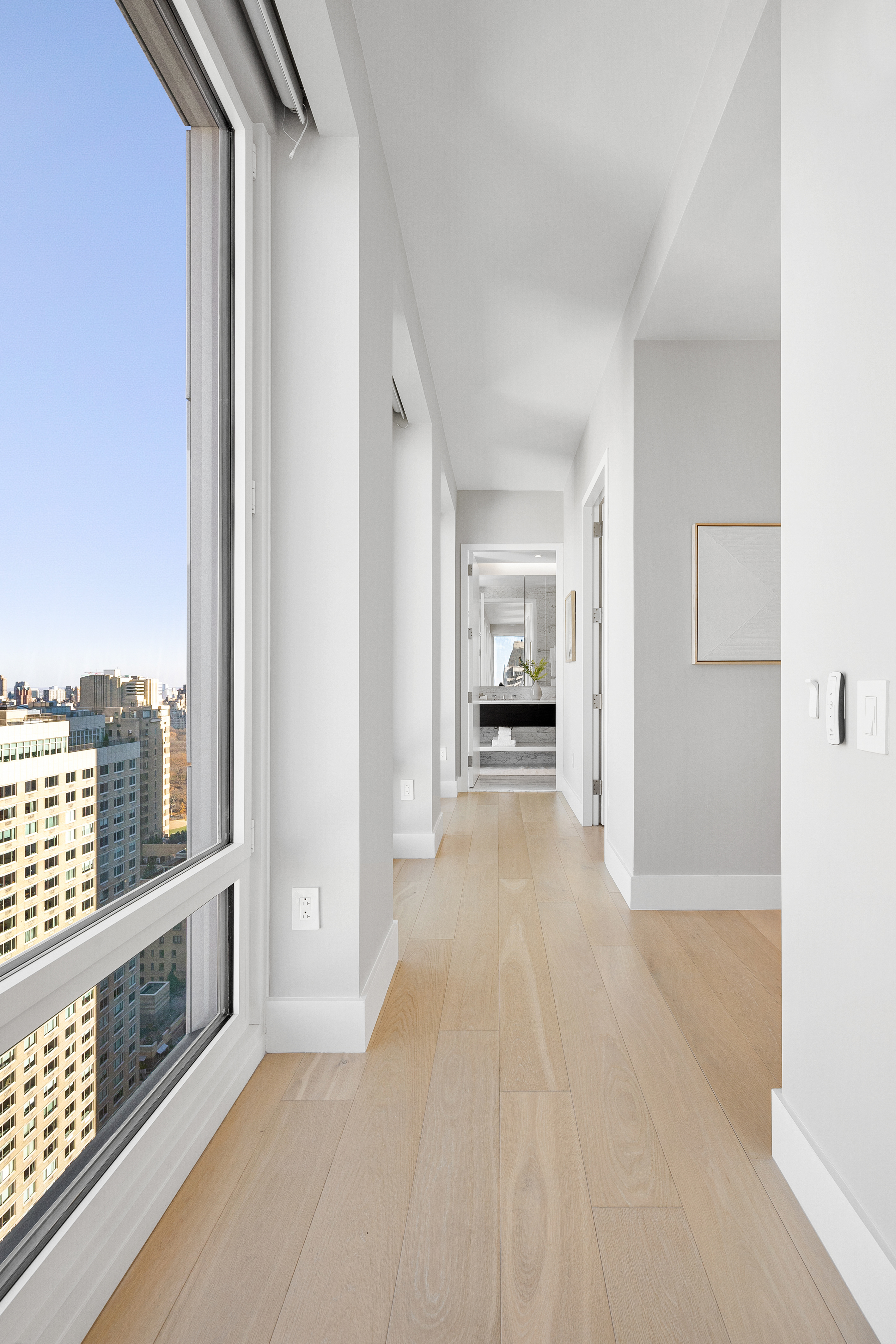 15 West 61st Street, Unit PH1C Manhattan, NY 10023 - Photo 17 of 26 a view of a living room hardwood floor and a kitchen