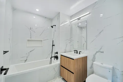 a bathroom with a sink a toilet and bathtub