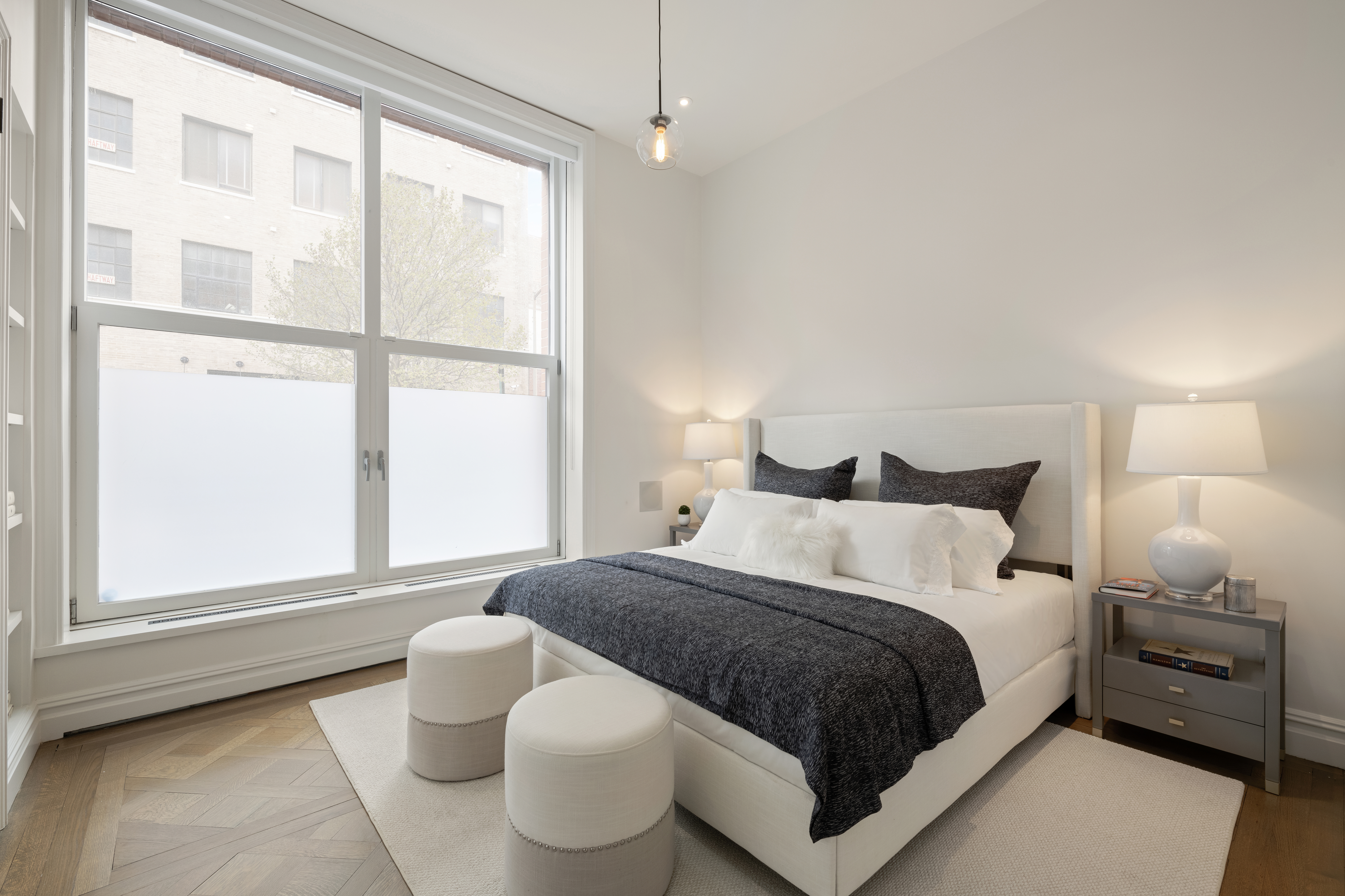 415 Washington Street, Unit 1B Manhattan, NY 10013 - Photo 8 of 16 a bedroom with a bed and window