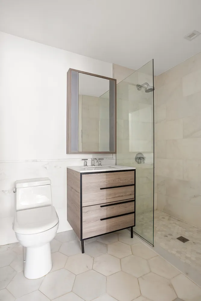 a bathroom with a toilet sink and mirror