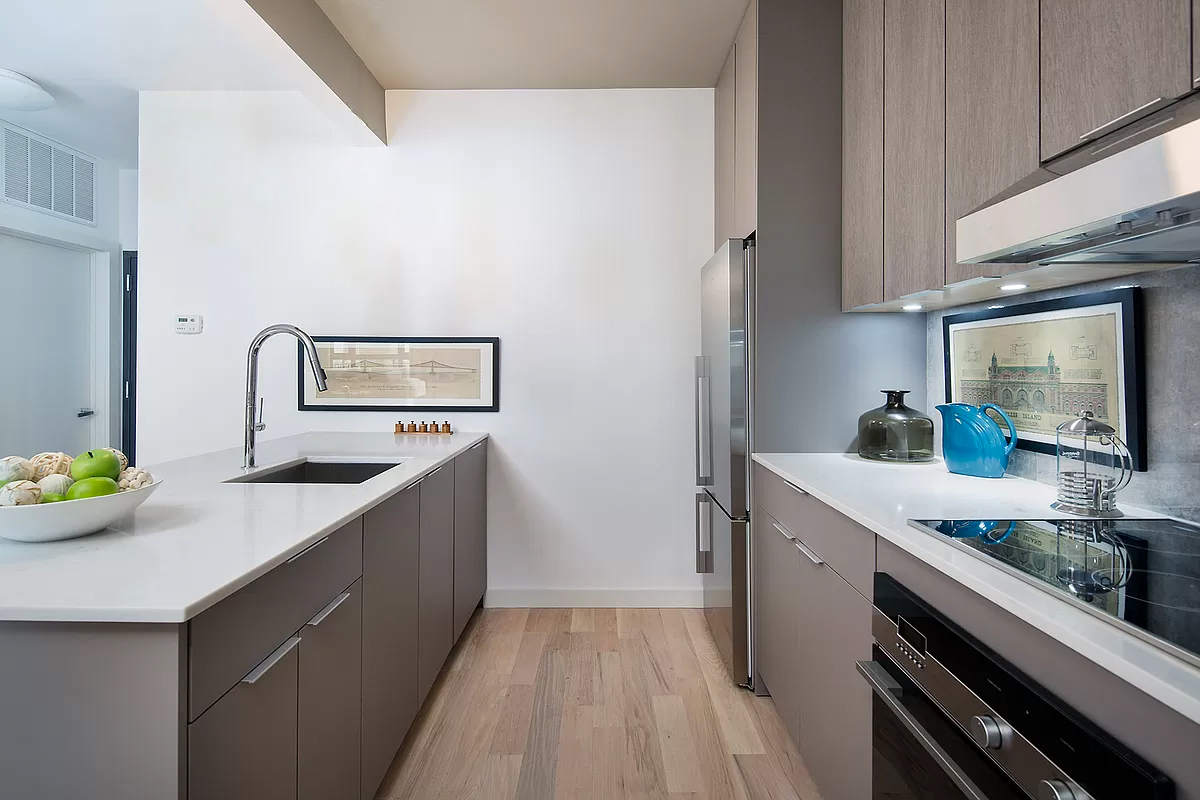 328 Central Avenue, Unit 3B Brooklyn, NY 11221 - Photo 5 of 11 a kitchen with stainless steel appliances a sink stove and cabinets