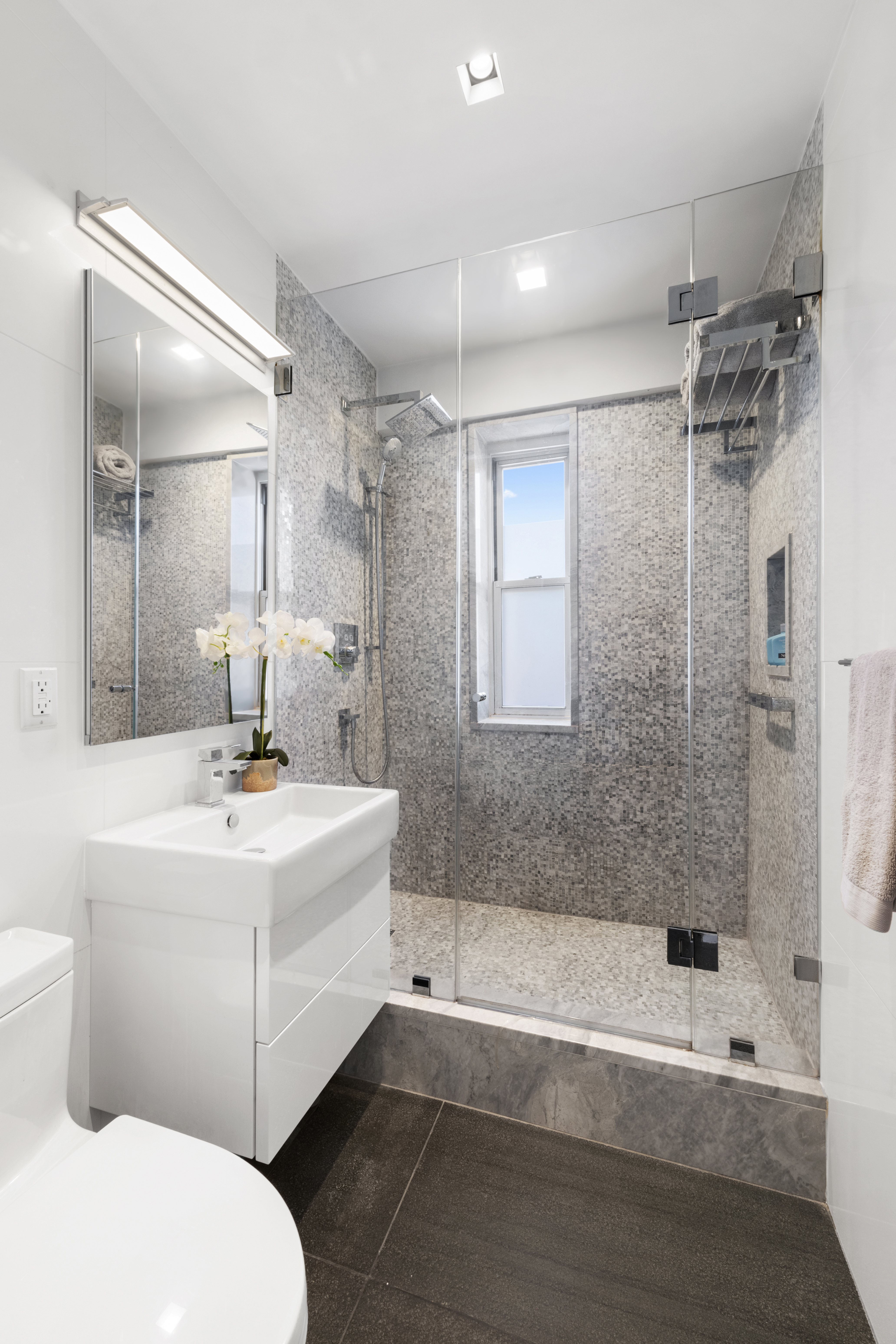 573 Grand Street, Unit D1707/1801 Manhattan, NY 10002 - Photo 13 of 24 a bathroom with a sink mirror toilet and bathtub