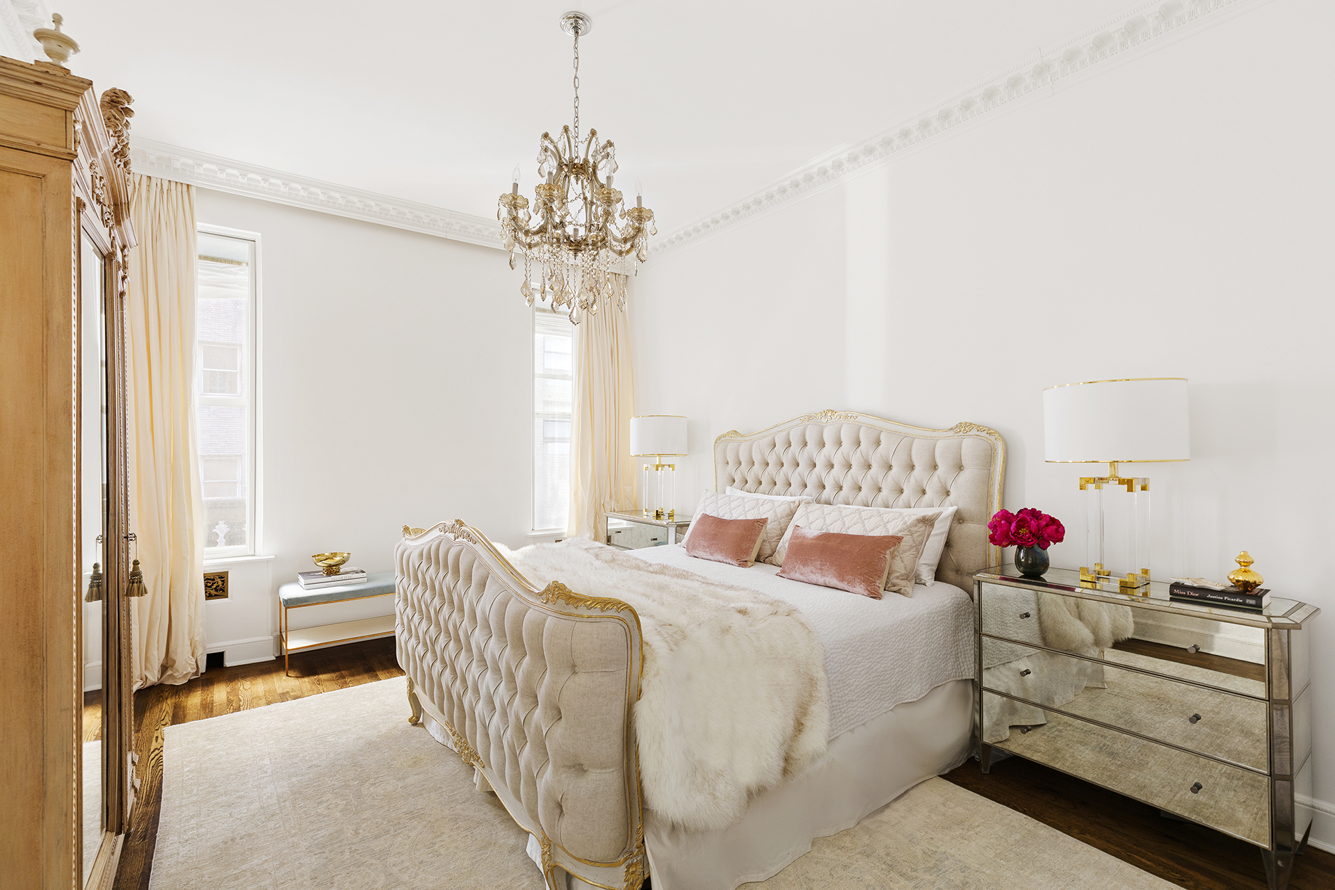 180 West 58th Street, Unit 5A Manhattan, NY 10019 - Photo 6 of 17 a bedroom with a bed and a chandelier