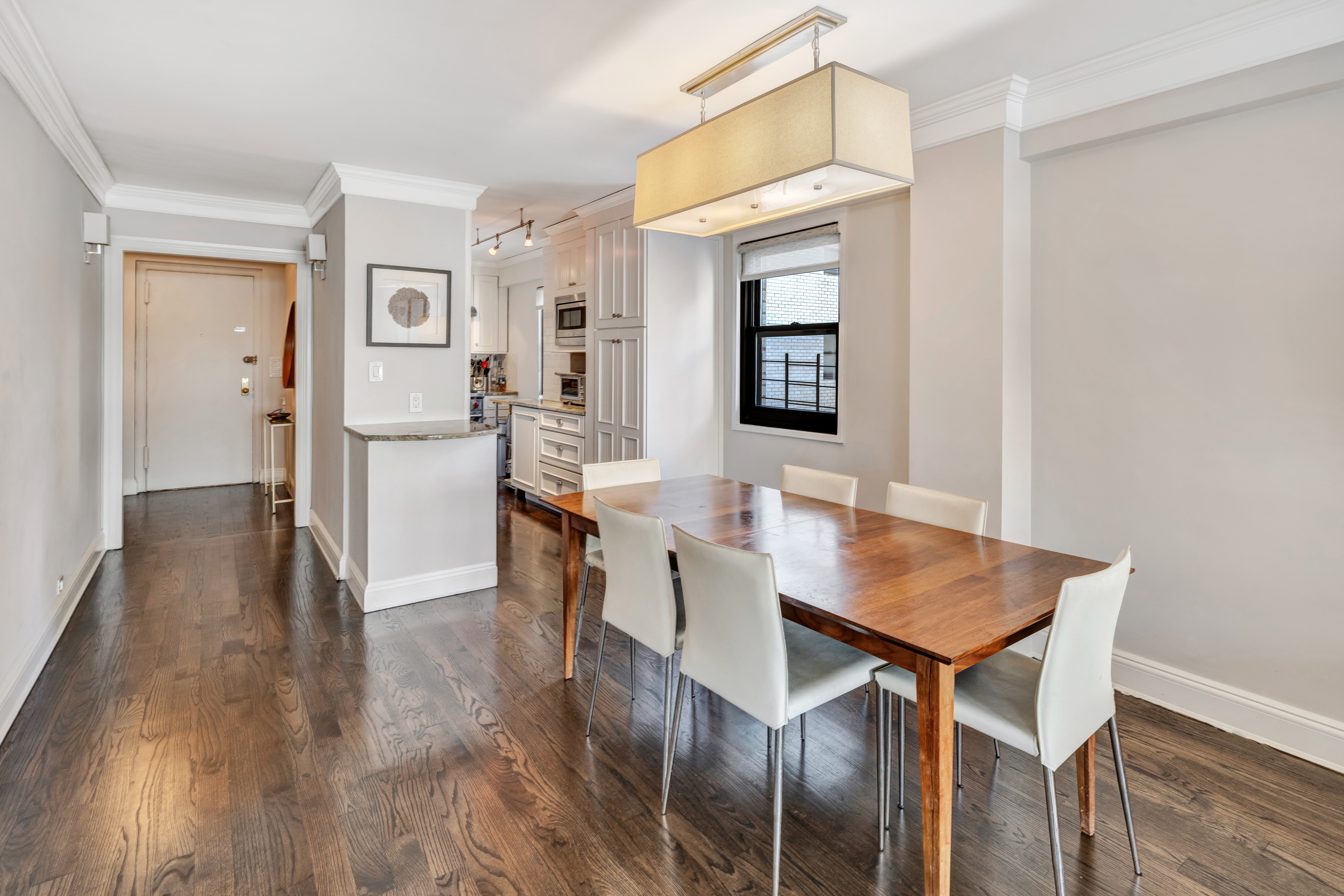 411 East 57th Street, Unit 11AB Manhattan, NY 10022 - Photo 6 of 17 a view of a dining room with furniture and wooden floor
