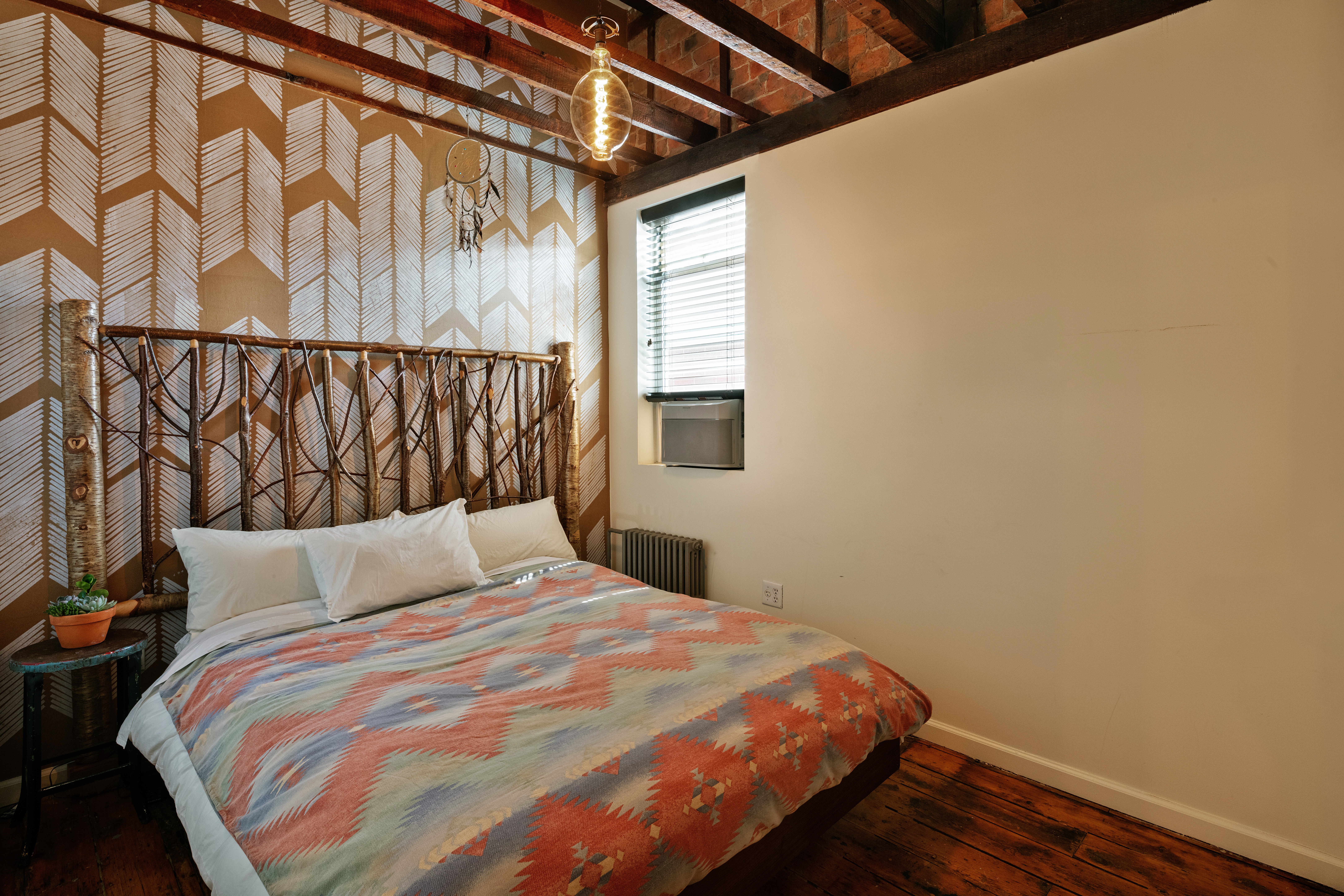 111 Powers Street Brooklyn, NY 11211 - Photo 15 of 16 a bedroom with a bed and a window