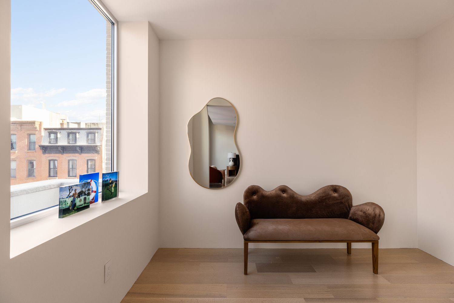 a living room with furniture and a mirror