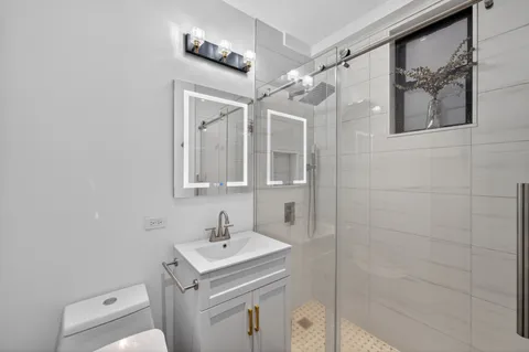 a bathroom with a sink toilet and shower