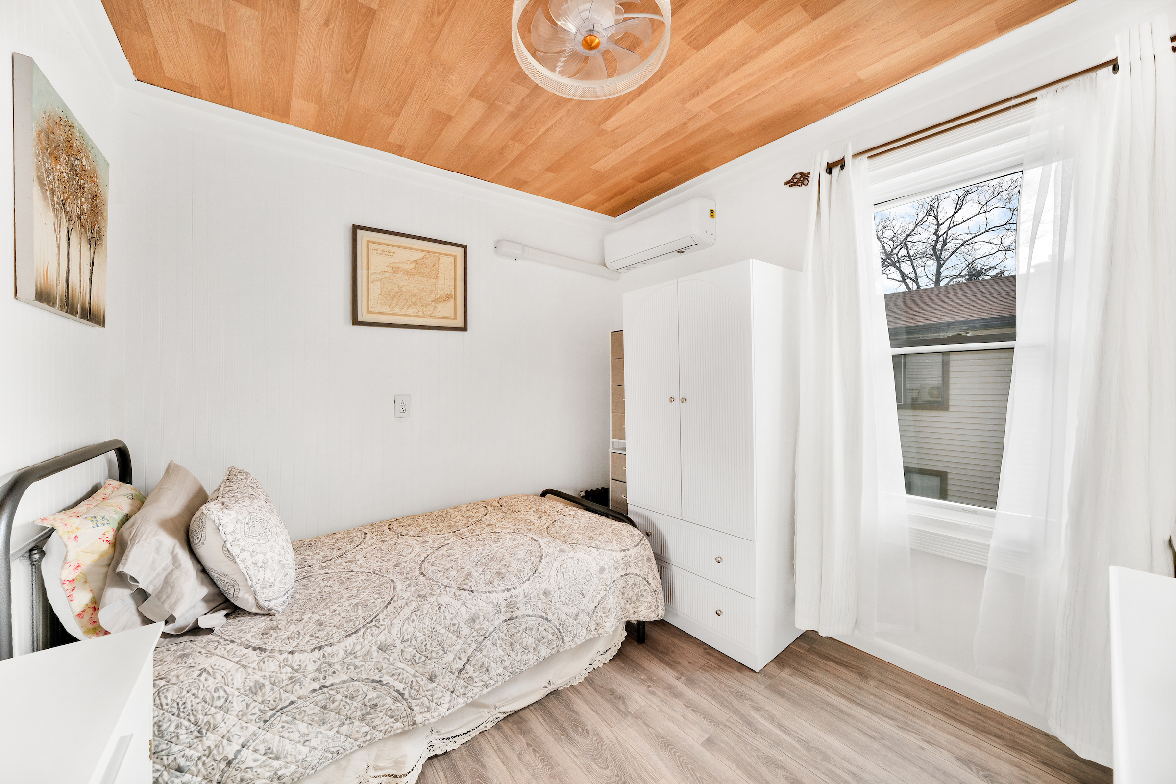 132-11 107th Avenue Queens, NY 11419 - Photo 8 of 14 a bedroom with a bed and a window