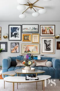 a living room with furniture and painting on the wall