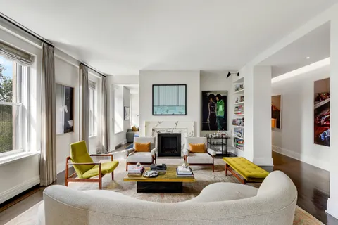 a living room with furniture fireplace and window