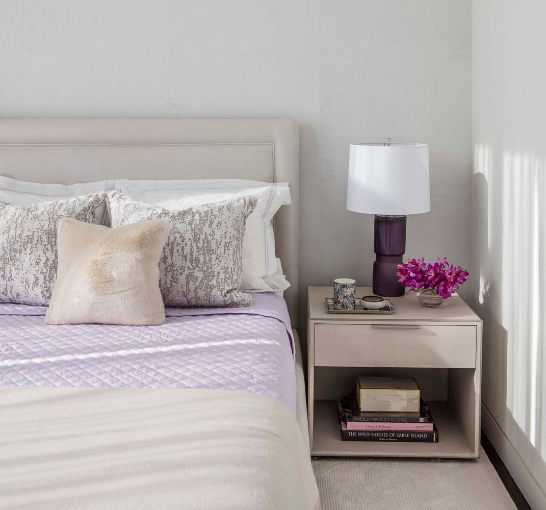 a bedroom with a bed and a lamp