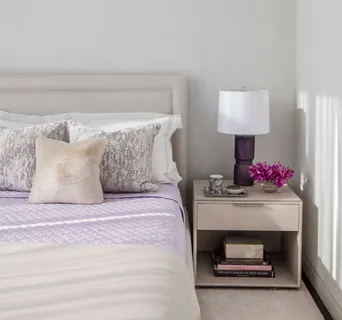 a bedroom with a bed and a lamp