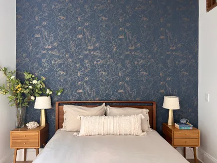 a bedroom with a bed and a lamp on table