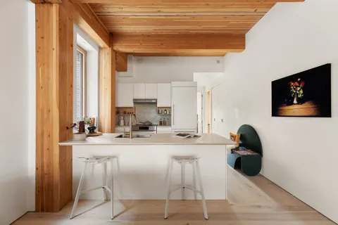 a living room with a flat screen tv and a large window