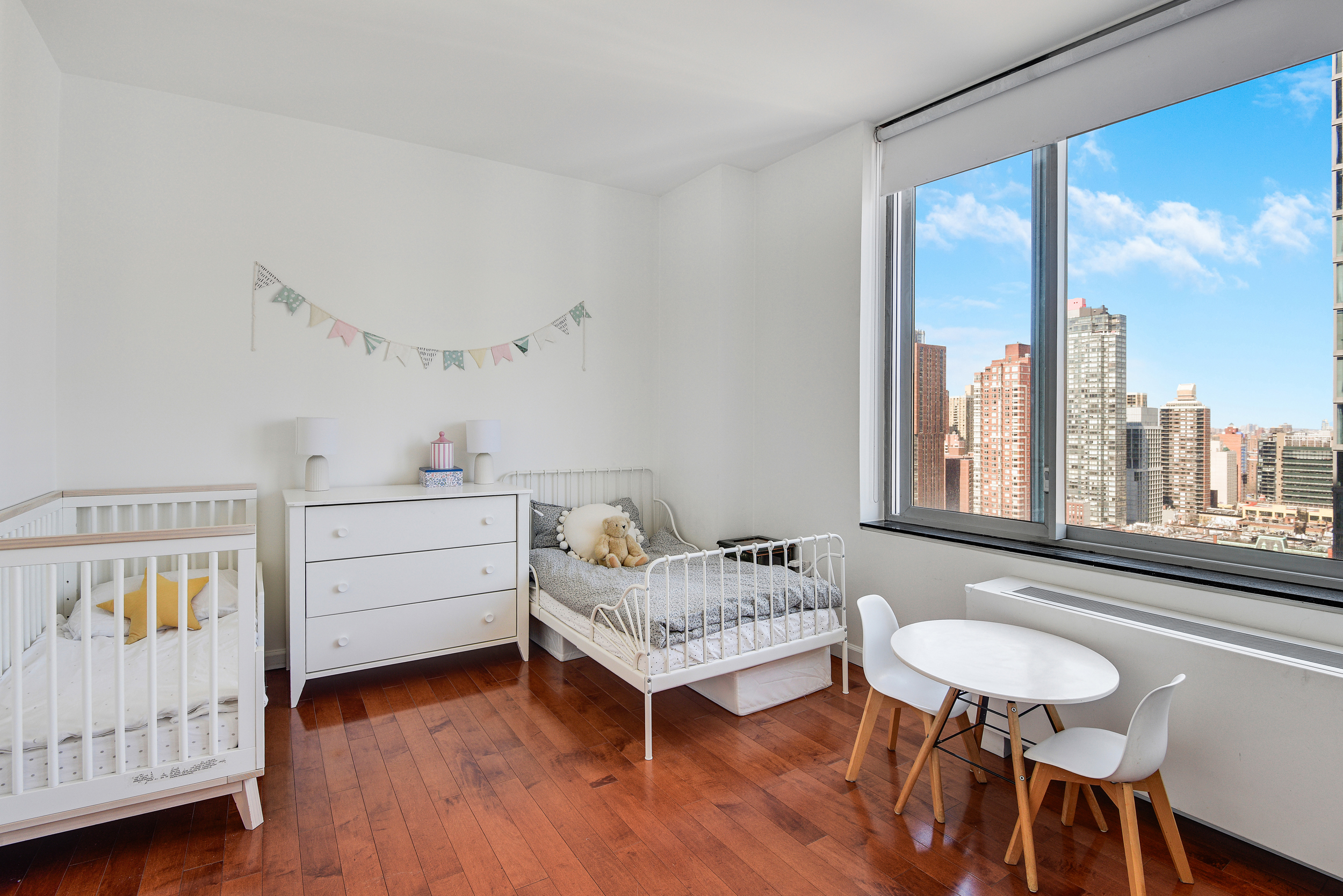 360 East 88th Street, Unit 22C Manhattan, NY 10128 - Photo 13 of 33 a bedroom with a bed and a window