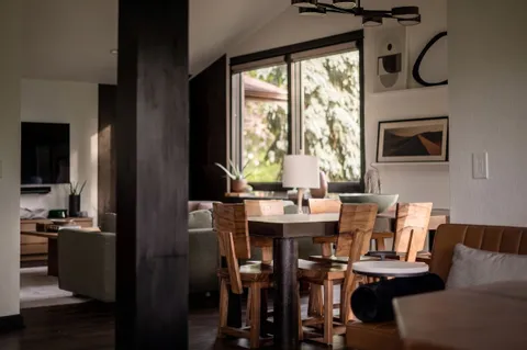 a kitchen with stainless steel appliances kitchen island wooden floors and white cabinets