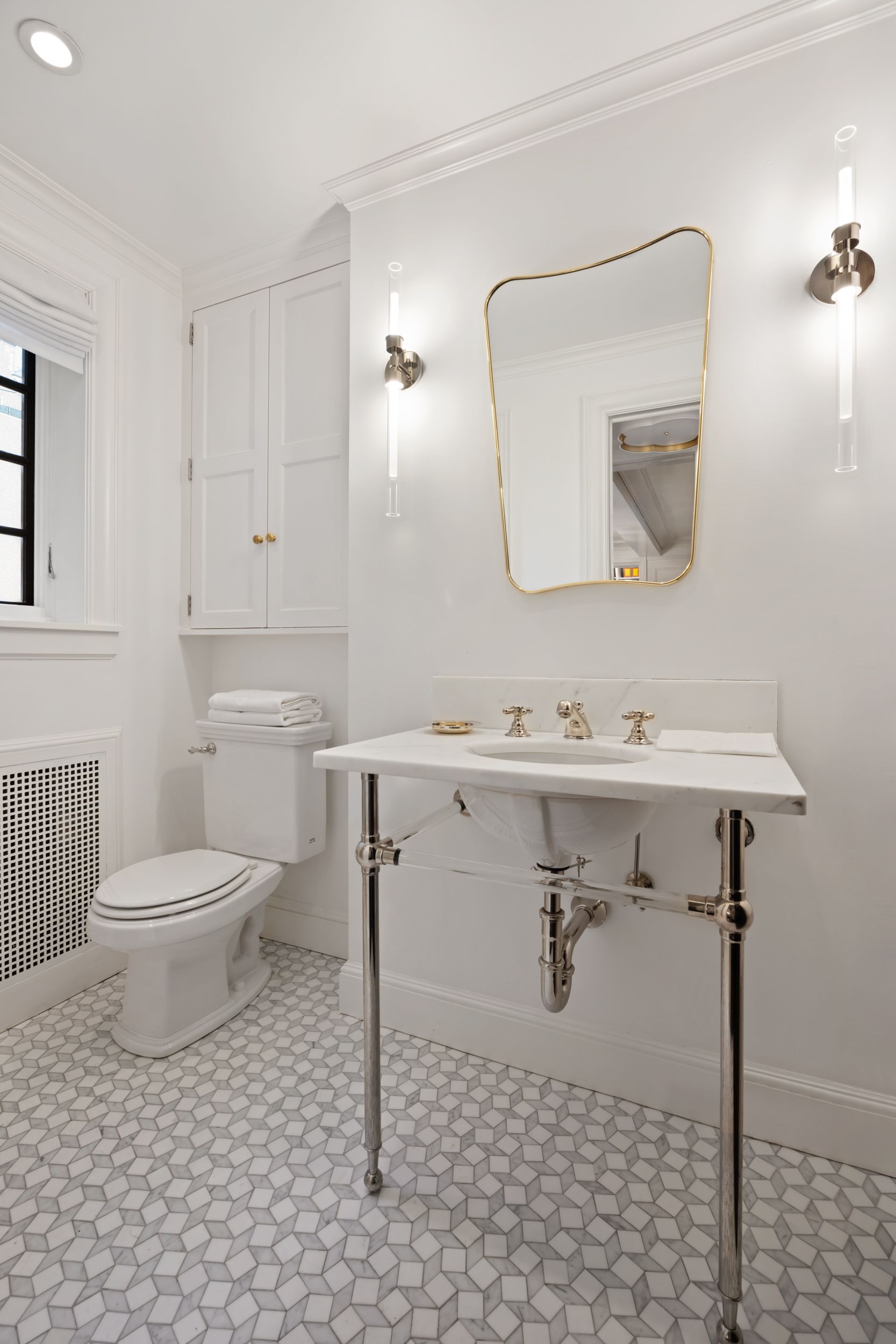 170 East 78th Street, Unit 8E Manhattan, NY 10075 - Photo 13 of 16 a bathroom with a sink toilet and mirror