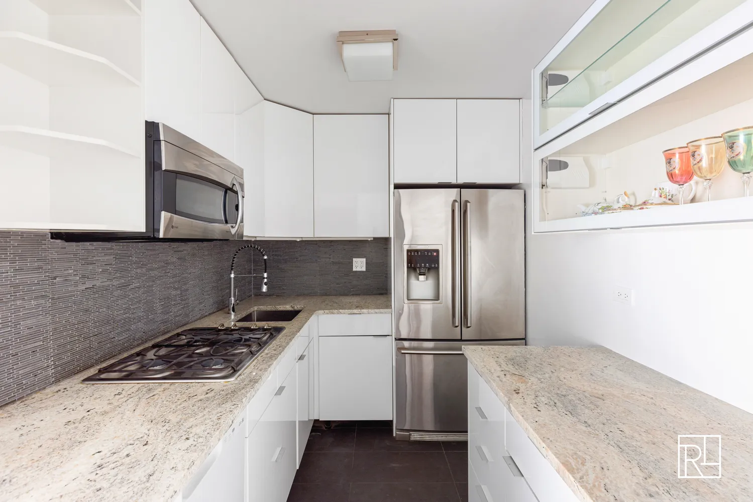a kitchen with refrigerator a stove a microwave and cabinets