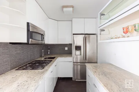 a kitchen with refrigerator a stove a microwave and cabinets