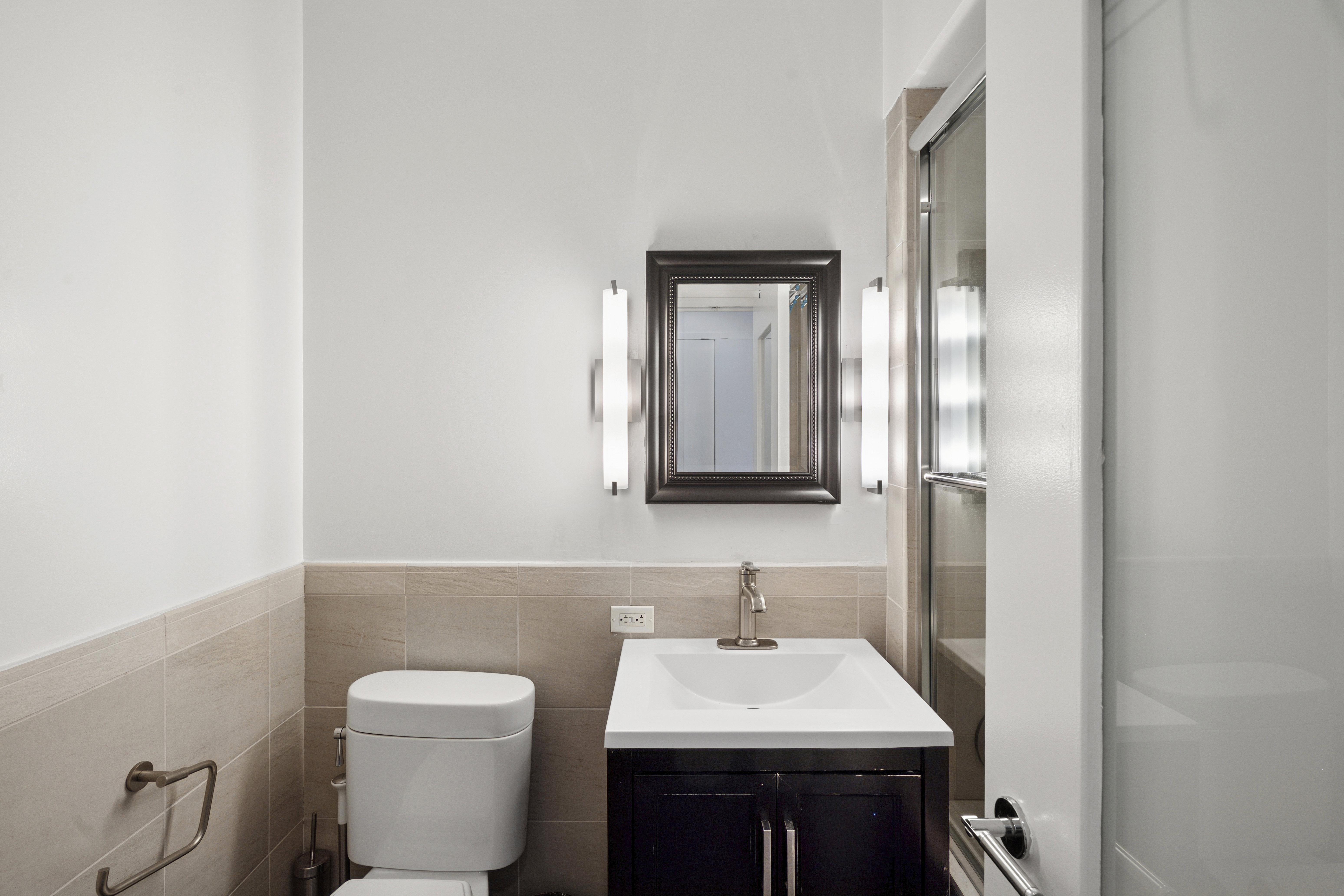 101 West 24th Street, Unit 16D Manhattan, NY 10011 - Photo 11 of 23 a bathroom with a toilet a sink and mirror