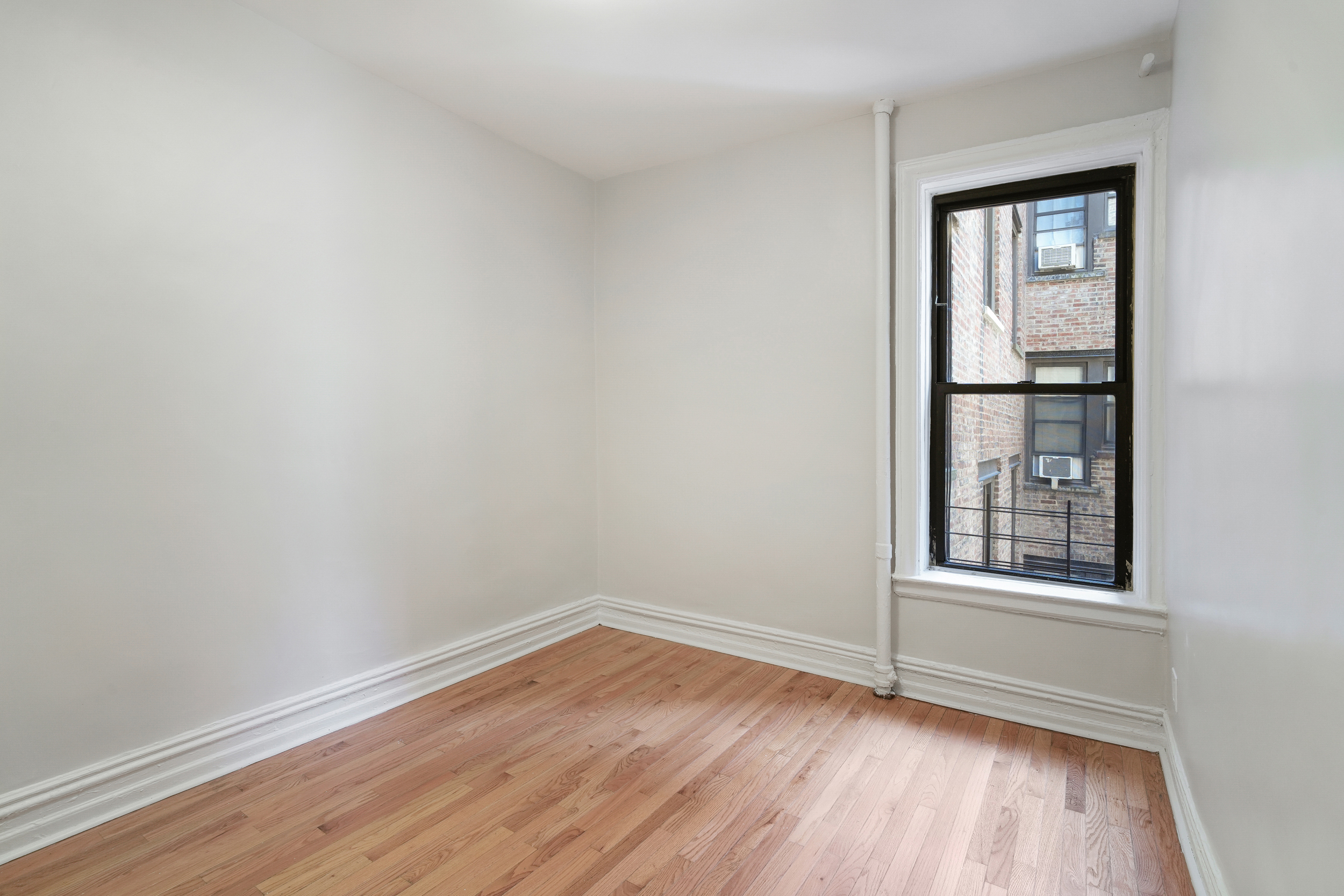200 West 109th Street, Unit C1 Manhattan, NY 10025 - Photo 13 of 16 wooden floor and window in an empty room