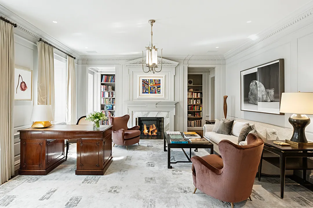 a living room with furniture a fireplace and a window