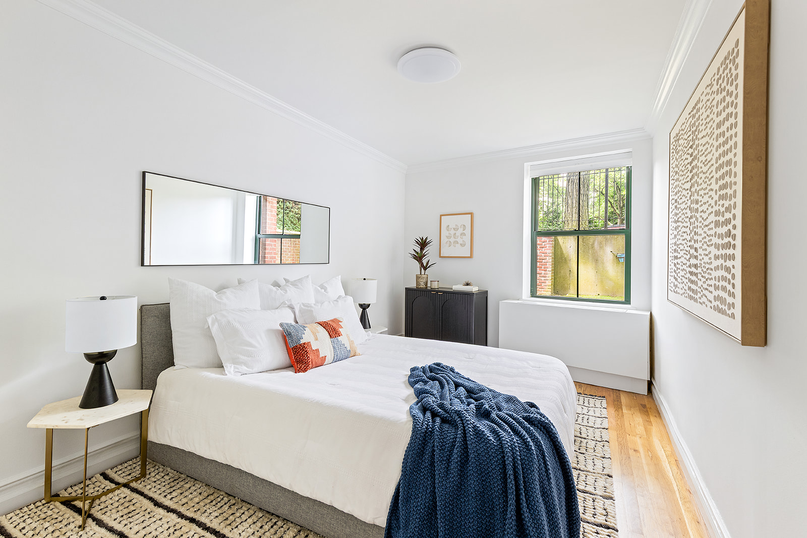 1139 Prospect Avenue, Unit 1L Brooklyn, NY 11218 - Photo 3 of 8 a bedroom with a bed and wooden floor