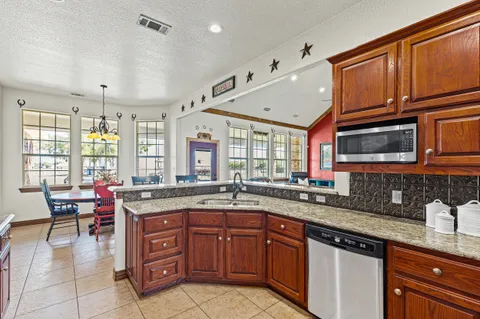 a kitchen with granite countertop a sink and a granite counter tops