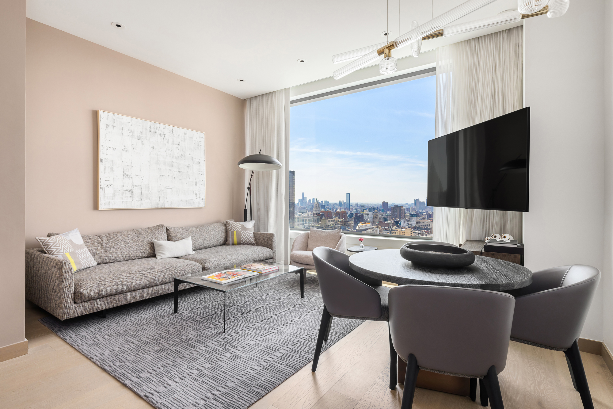 25 West 28th Street, Unit PH42B Manhattan, NY 10001 - Photo 2 of 15 a living room with furniture and a flat screen tv