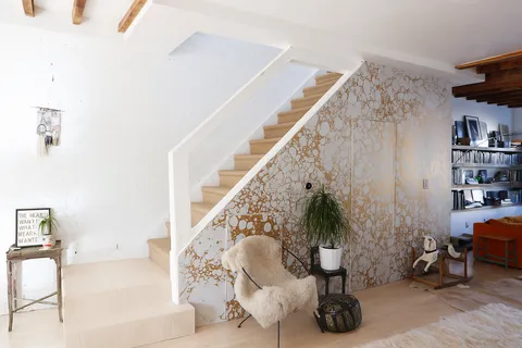a living room with furniture and a potted plant