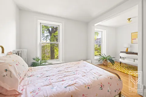 a bedroom with a bed and a window