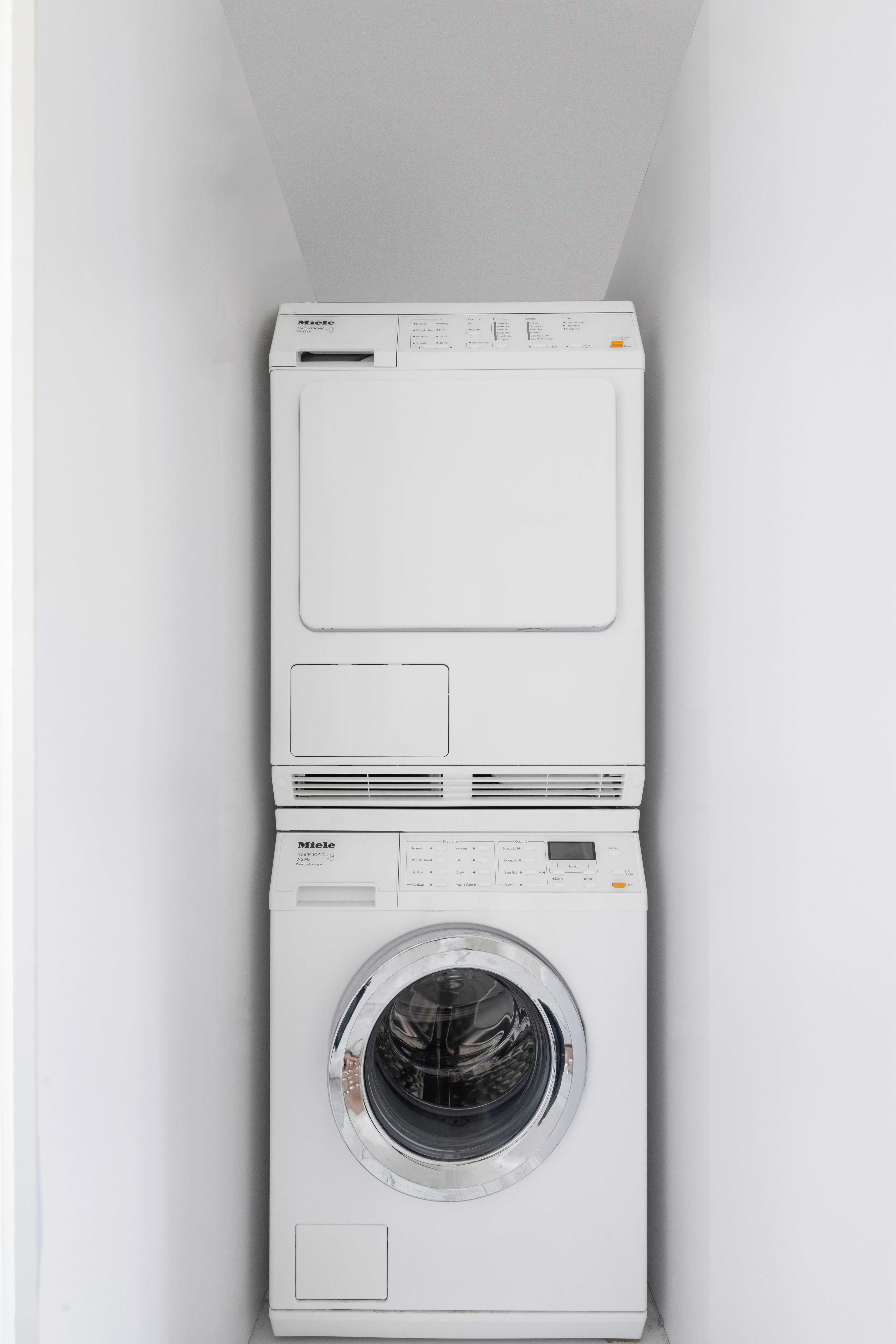 135 Ridge Street, Unit 5A Manhattan, NY 10002 - Photo 7 of 11 a close up view of a washer and dryer