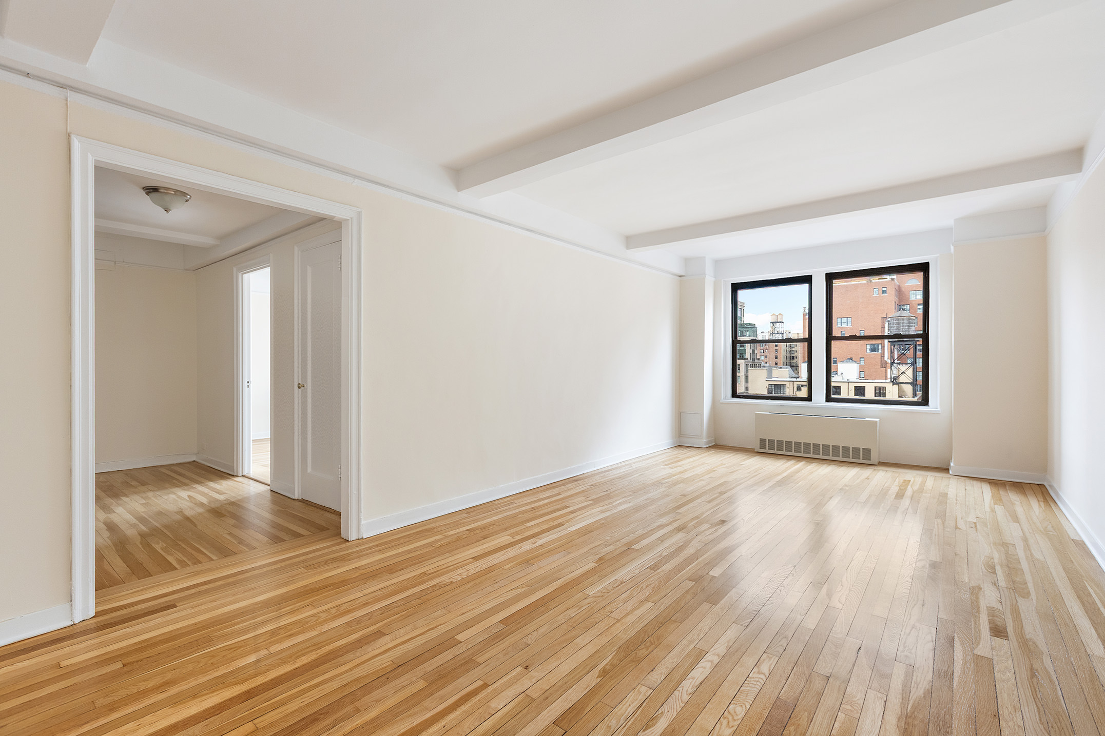 205 East 78th Street, Unit 14C Manhattan, NY 10075 - Photo 6 of 12 wooden floor in an empty room with a window