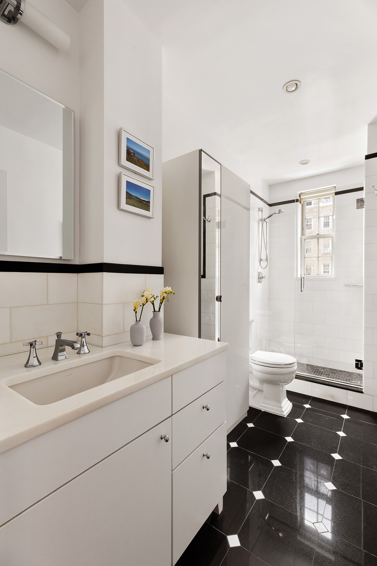 25 5th Avenue, Unit 8F Manhattan, NY 10003 - Photo 8 of 9 a bathroom with a granite countertop double vanity and mirrors