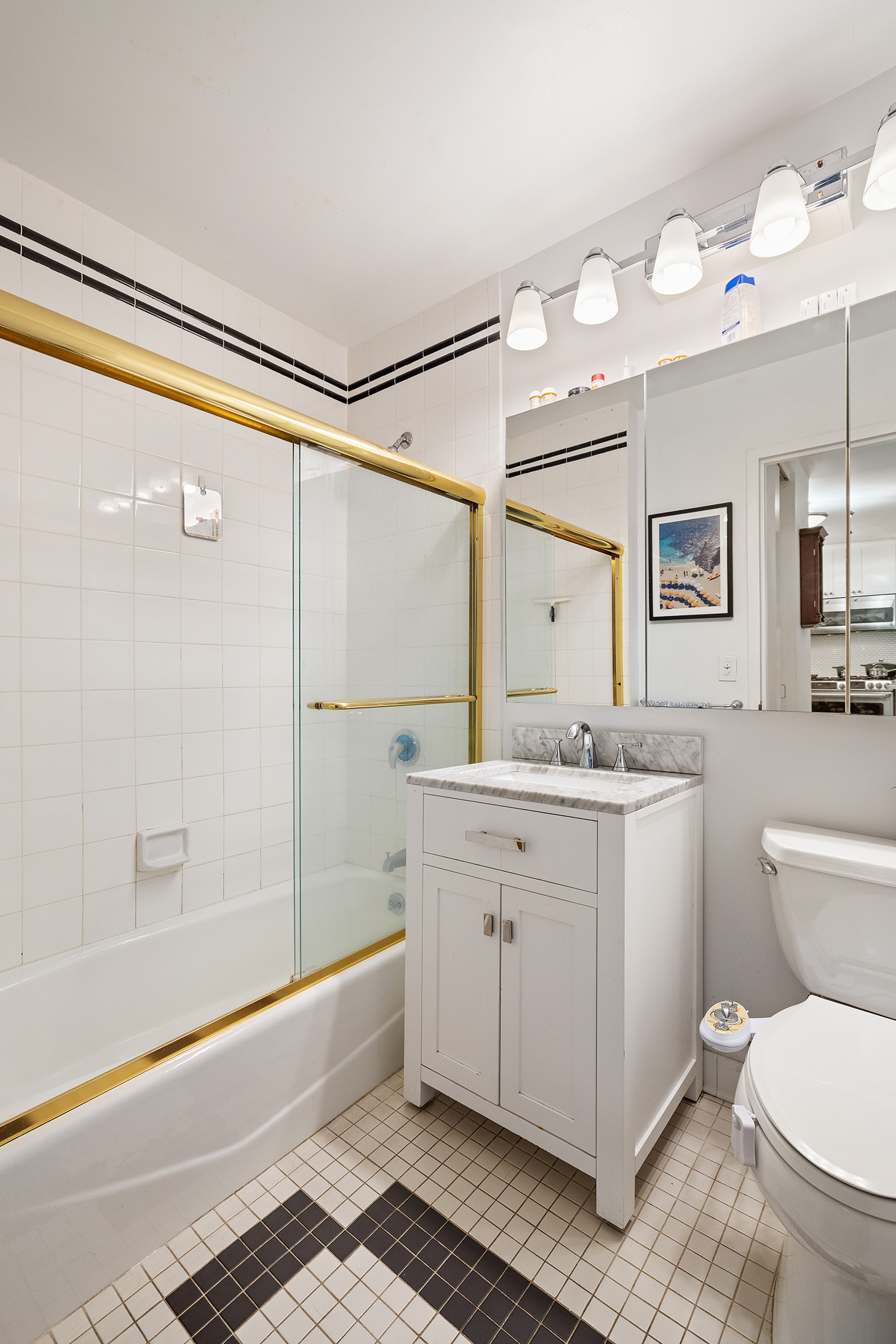 22 West 15th Street, Unit 10G Manhattan, NY 10011 - Photo 5 of 11 a bathroom with a granite countertop sink toilet and shower