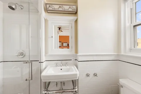 a bathroom with a sink a toilet and mirror