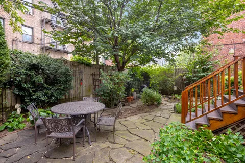 a view of a chair and table in the backyard