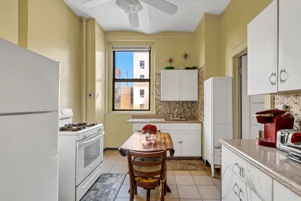 a kitchen with stainless steel appliances kitchen island granite countertop a refrigerator and a stove