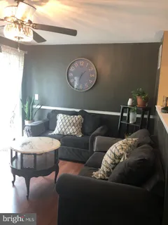 a dining room with furniture a fireplace and wooden floor