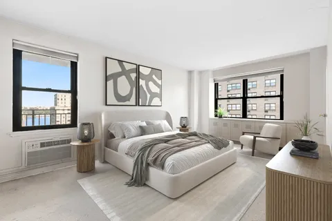 a bedroom with a bed a large mirror and a large window