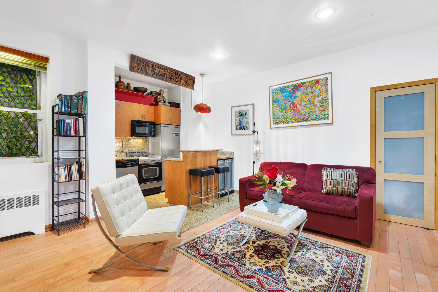 57 West 58th Street, Unit 3D Manhattan, NY 10019 - Photo 1 of 7 a living room with furniture and a rug
