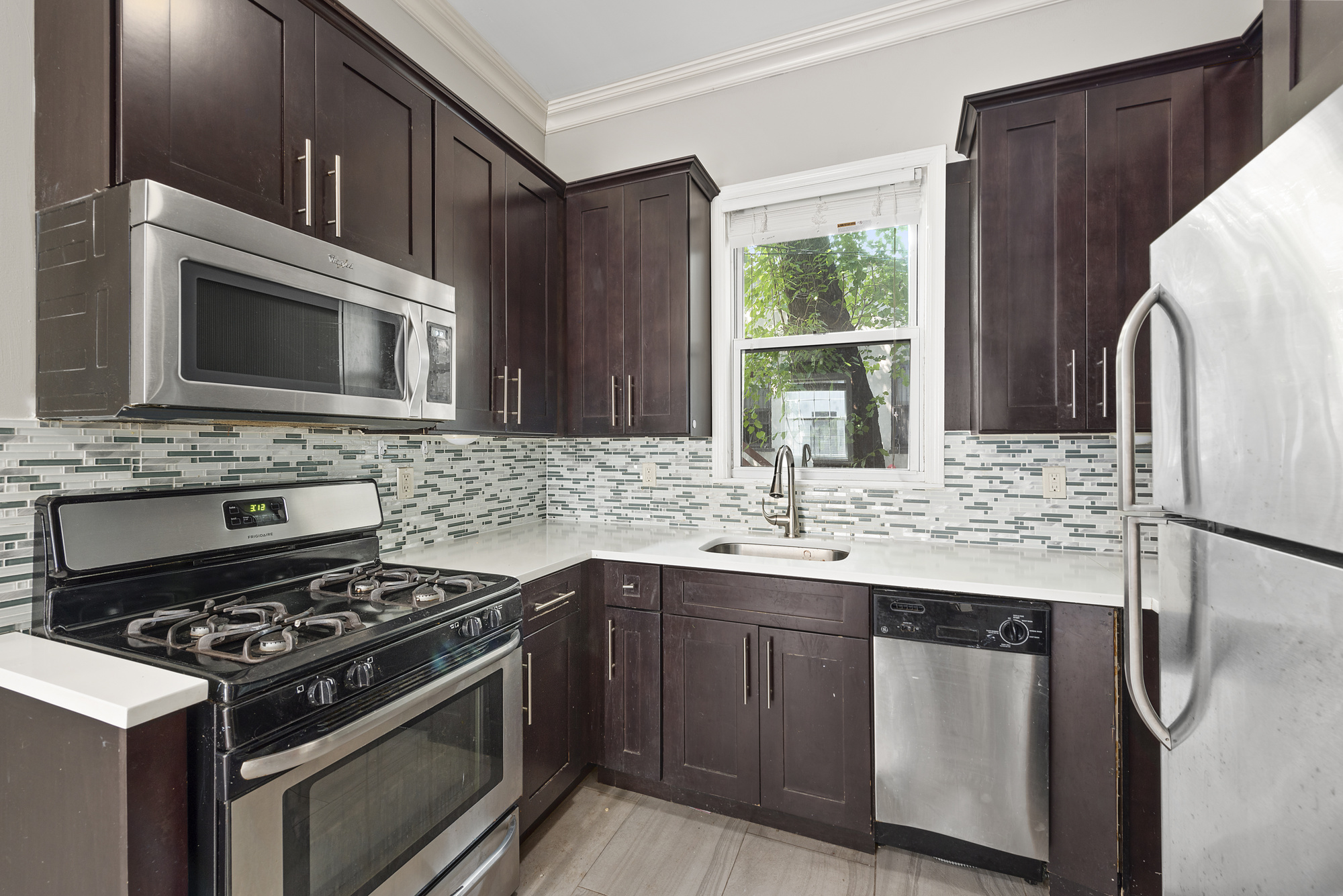 527 Carroll Street, Unit 1R Brooklyn, NY 11215 - Photo 3 of 9 a kitchen with stainless steel appliances granite countertop a sink stove and refrigerator