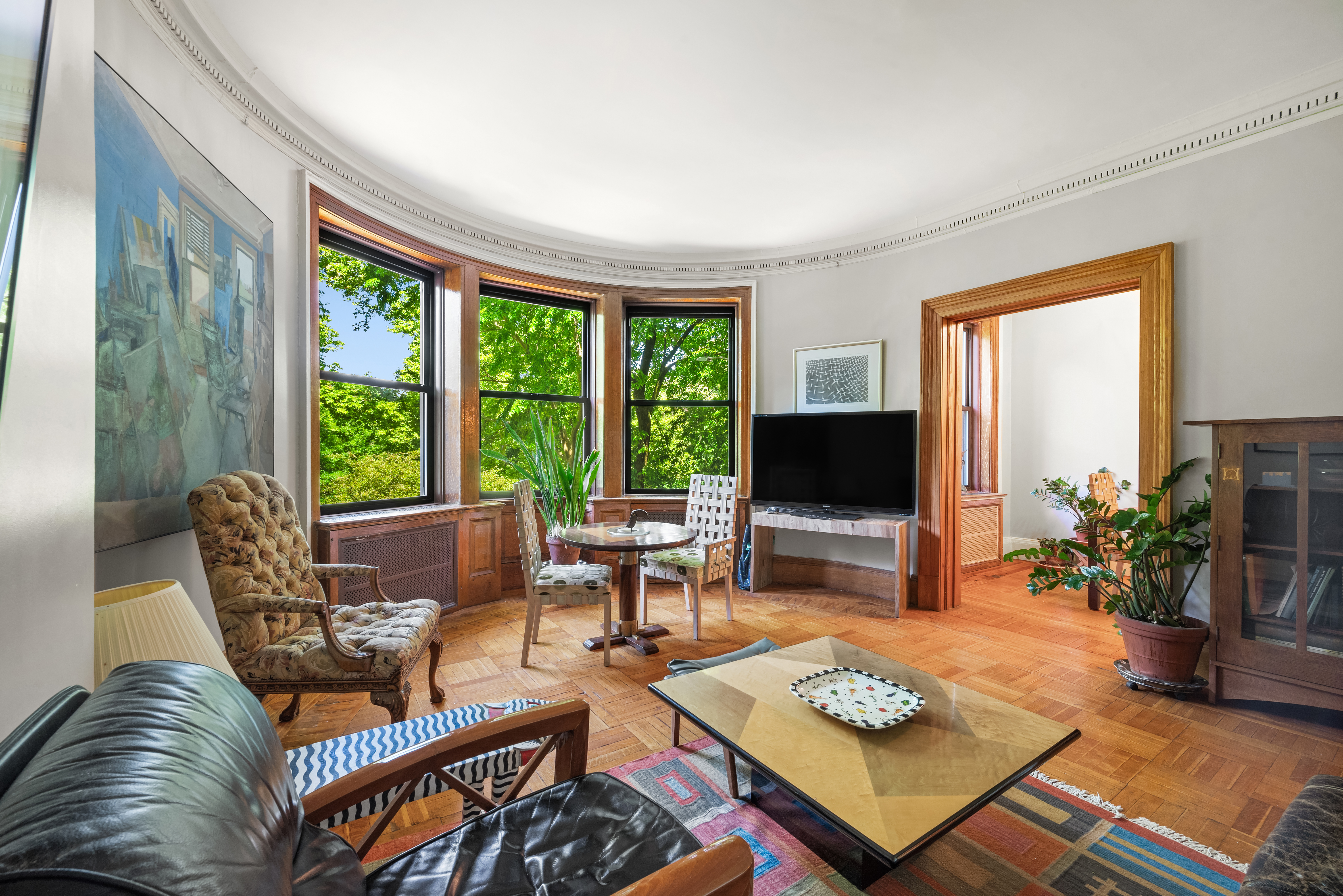 293 Riverside Drive, Unit 3A/4A Manhattan, NY 10025 - Photo 2 of 9 a living room with furniture and a flat screen tv