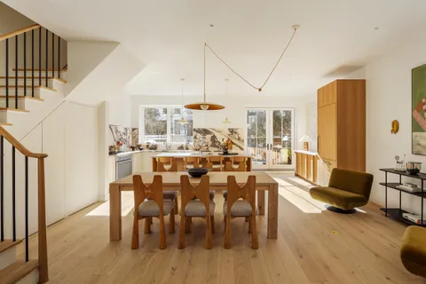 a view of a dining room with furniture window and wooden floor