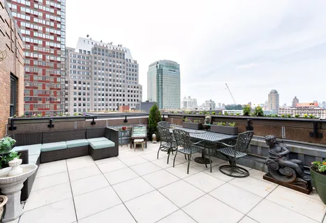 a terrace with outdoor seating and city view