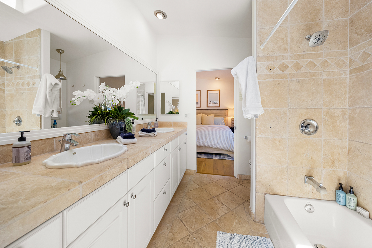 161 Loureyro Road Montecito, CA 93108 - Photo 15 of 52 a bathroom with a double vanity sink a large mirror a shower and bathtub