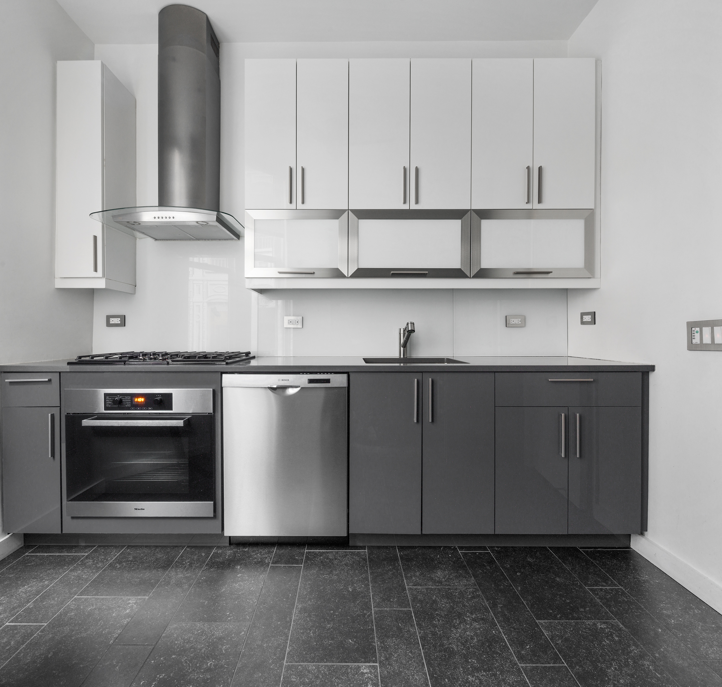 180 West 58th Street, Unit 11A Manhattan, NY 10019 - Photo 8 of 17 a kitchen with stainless steel appliances granite countertop a sink a stove and a refrigerator