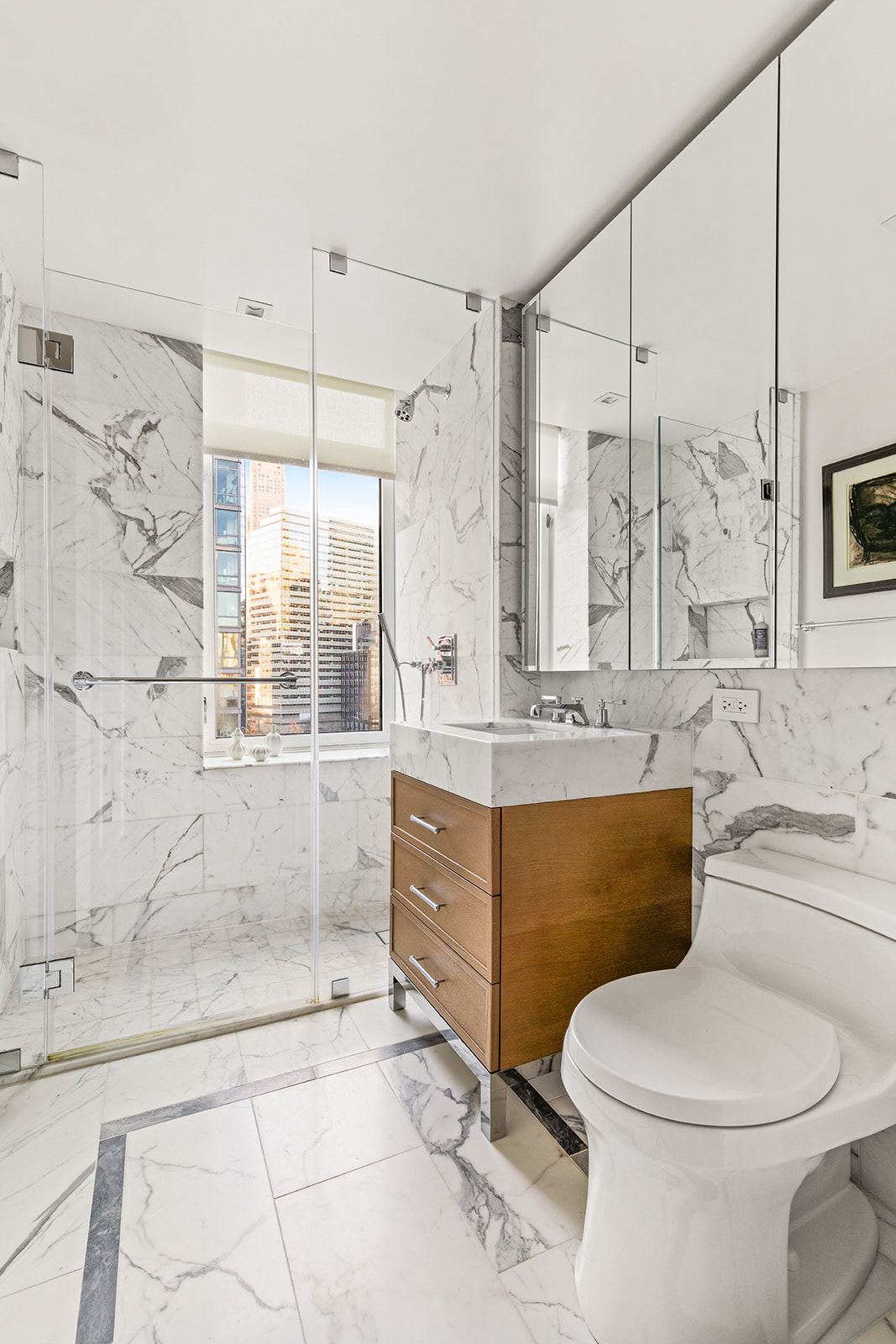 210 Warren Street, Unit 10G Manhattan, NY 10282 - Photo 8 of 15 a bathroom with a granite countertop toilet sink and mirror